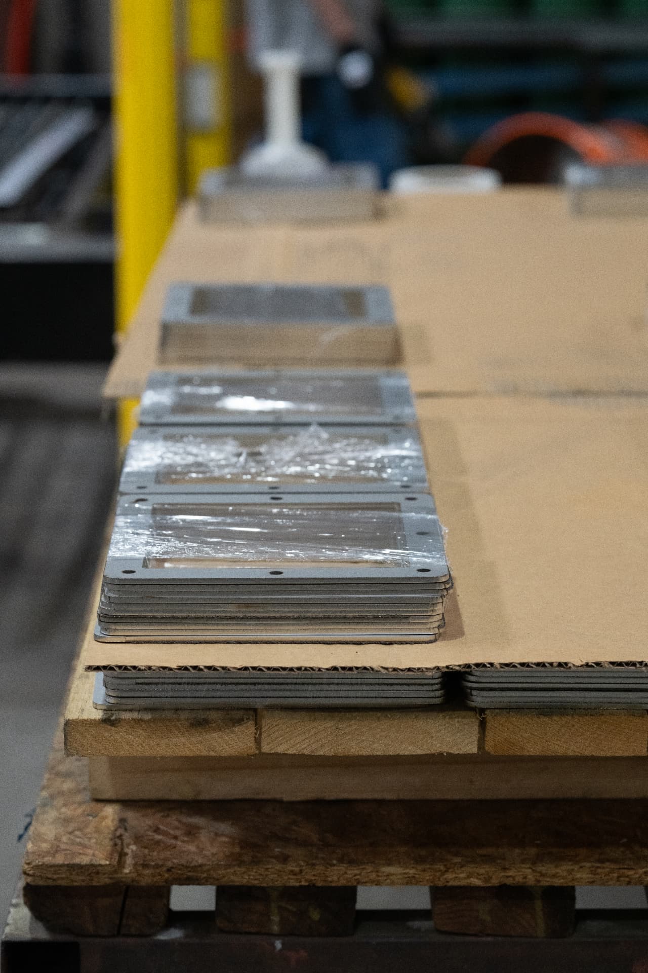 Stack of precision-machined steel plates ready for inspection