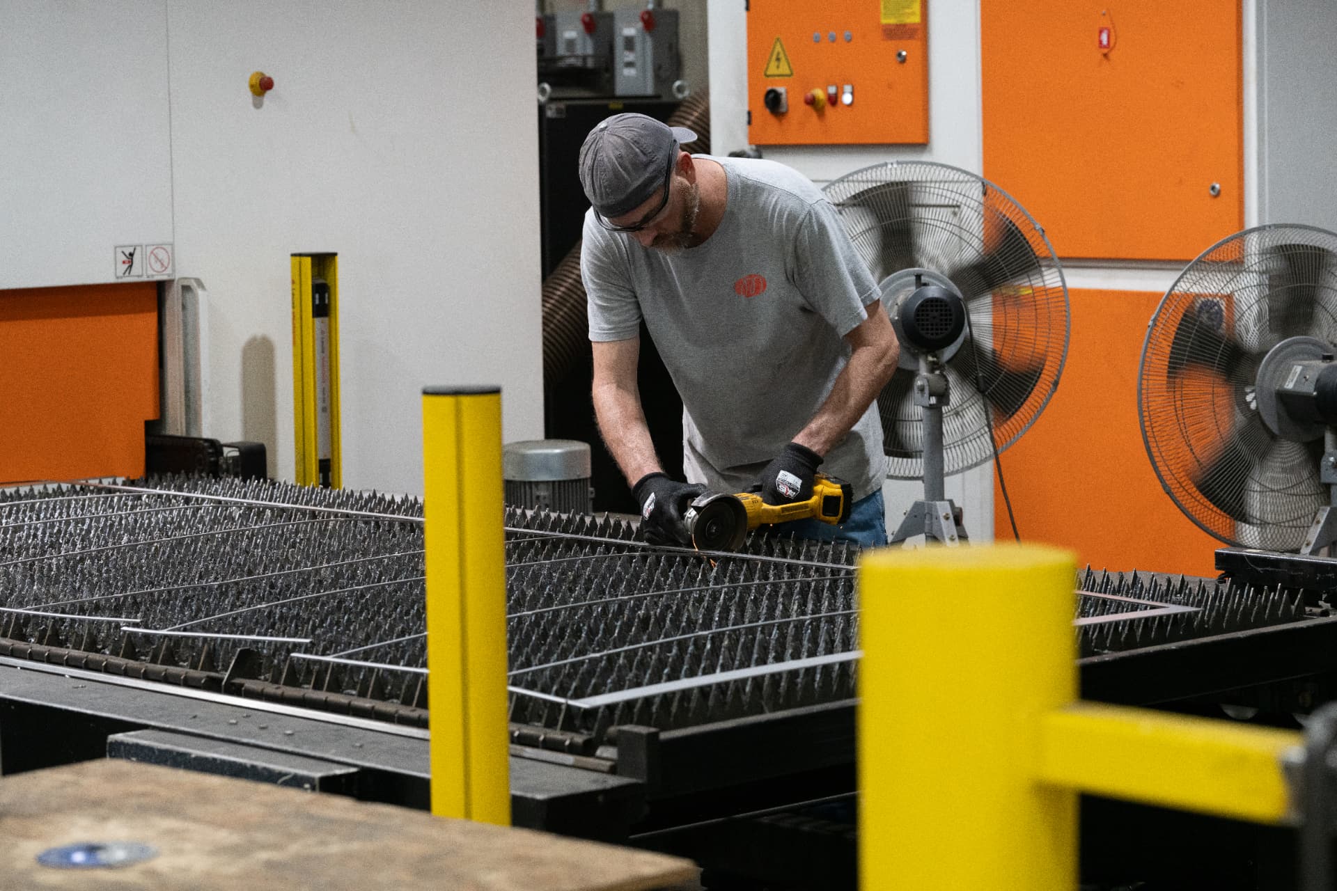 Fabricator finishing a cut steel plate before welding