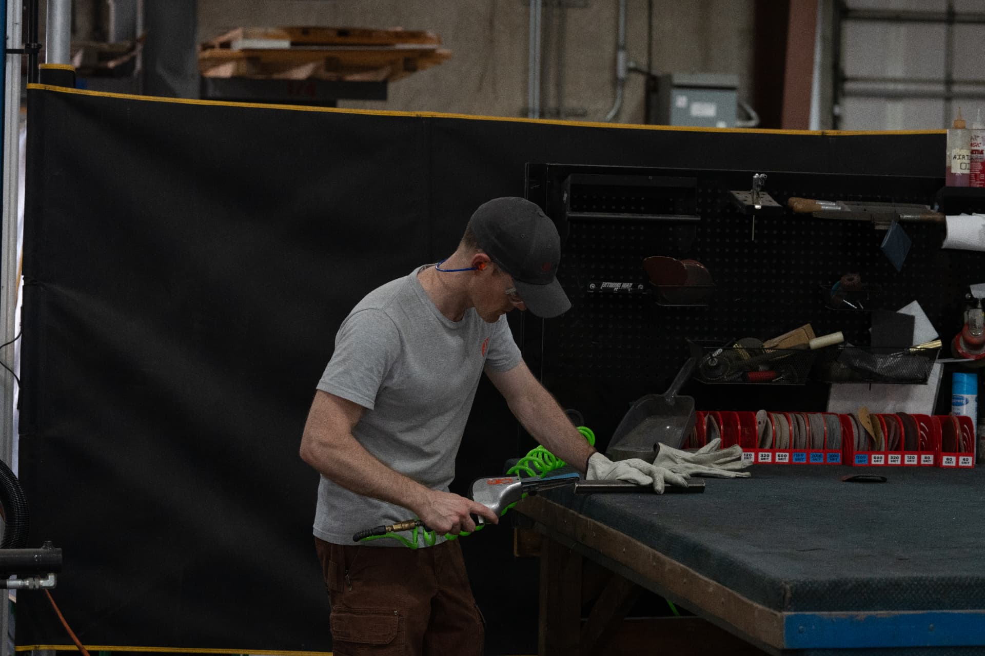 Mueller fabricator finishing a component at the bench