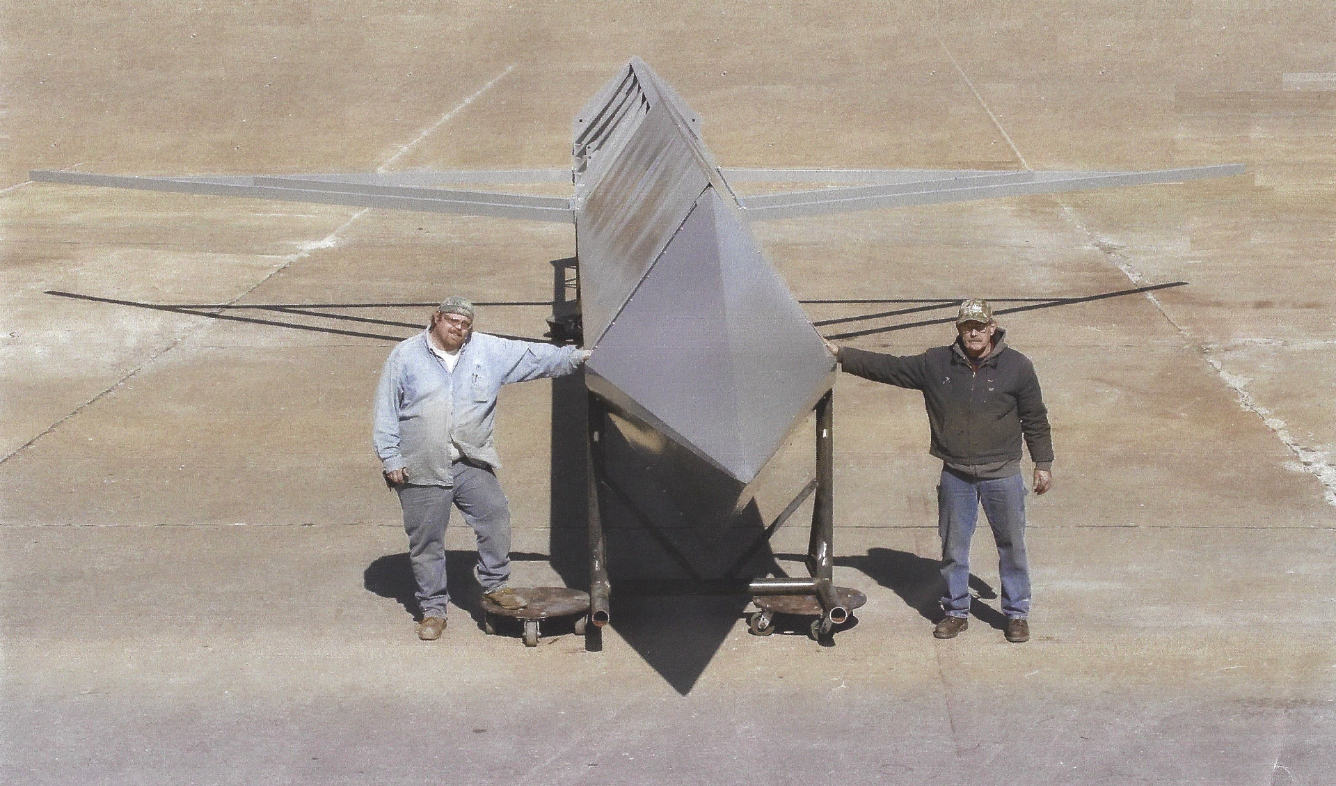 The crew behind the build — custom hopper assembly, ready to ship