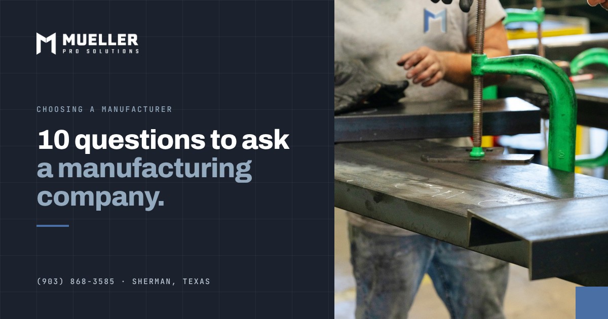Two Mueller Pro Solutions welders at a fabrication table in the Sherman, TX shop, one holding a welding helmet